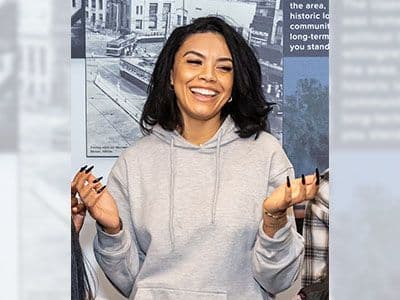 Alex Holt in gray sweatshirt