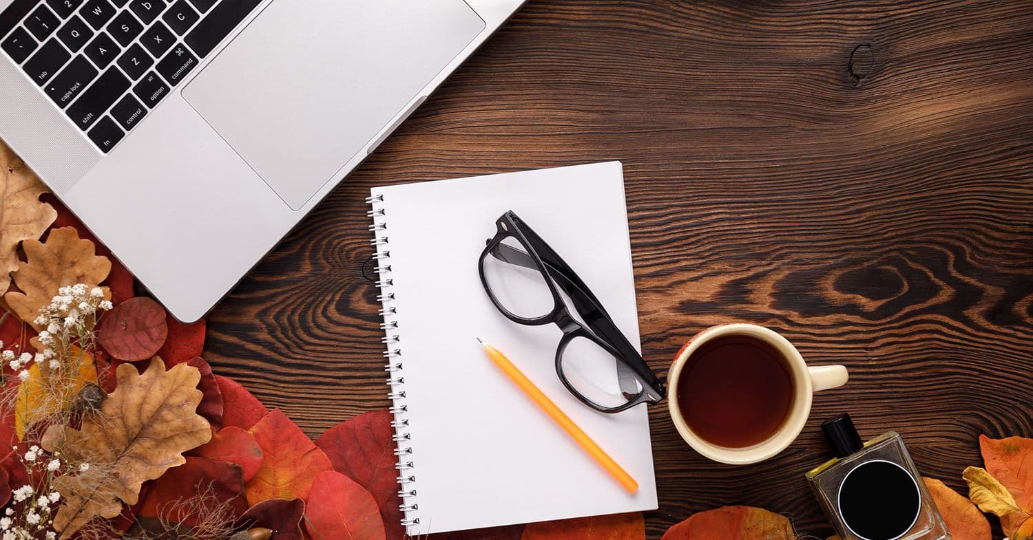 Nonprofit marketer’s desk on Giving Tuesday morning with a checklist, coffee mug, laptop