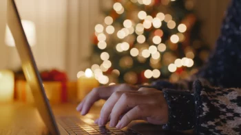 Working on laptop in front of Christmas tree