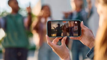 Woman recording three friends on a video